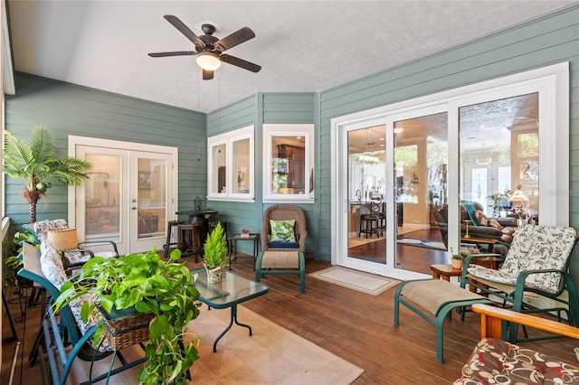 sunroom / solarium featuring ceiling fan and french doors