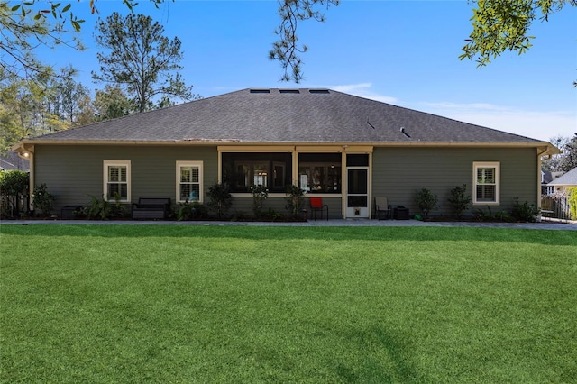 rear view of property with a lawn