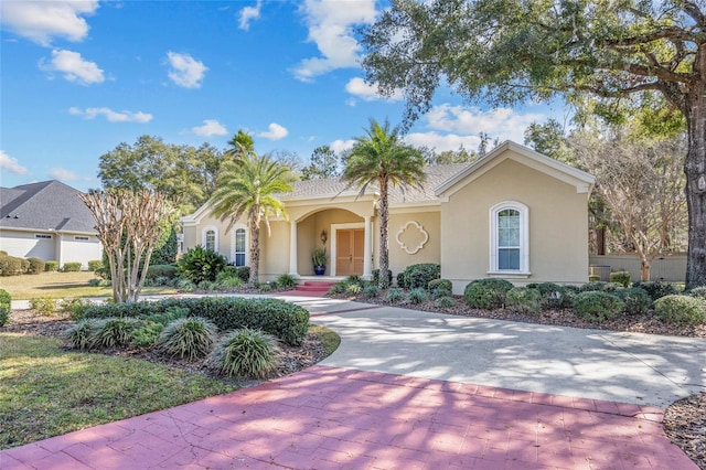 view of front facade featuring decorative driveway and stucco siding