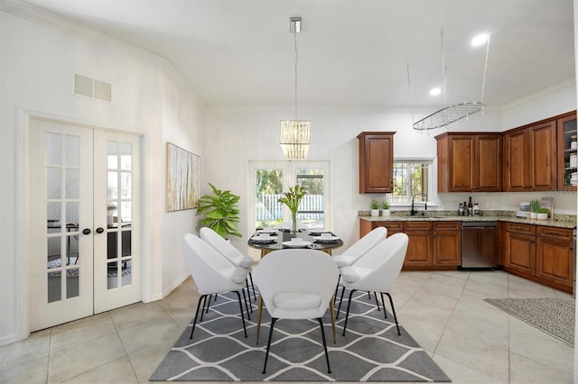 kitchen featuring visible vents, pendant lighting, a sink, and french doors