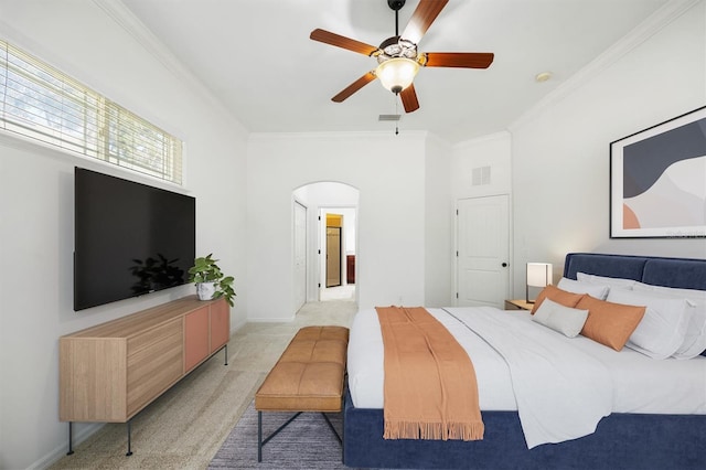 bedroom featuring baseboards, arched walkways, ornamental molding, and light colored carpet