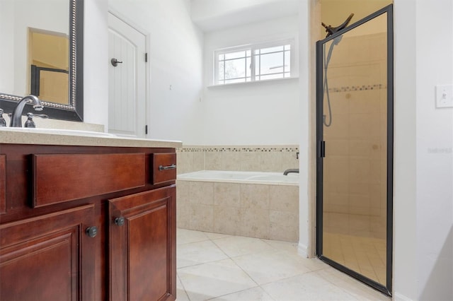 bathroom featuring a stall shower, a garden tub, vanity, and tile patterned floors