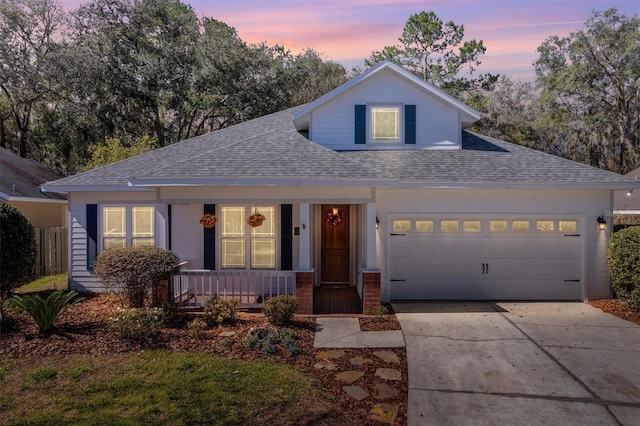 view of front of house with a garage, driveway, a porch, and roof with shingles