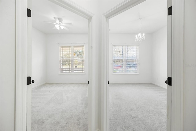 7572 SW 82nd Way, Gainesville, FL 32608 - carpeted spare room with a chandelier, baseboards, and a ceiling fan