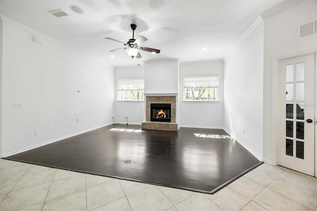 7572 SW 82nd Way, Gainesville, FL 32608 - unfurnished living room with ornamental molding, ceiling fan, a tile fireplace, tile patterned floors, and baseboards