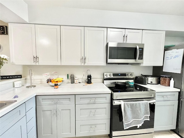 kitchen featuring stainless steel appliances and white cabinets