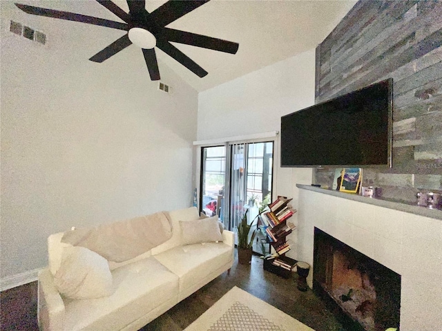 living room with ceiling fan and high vaulted ceiling