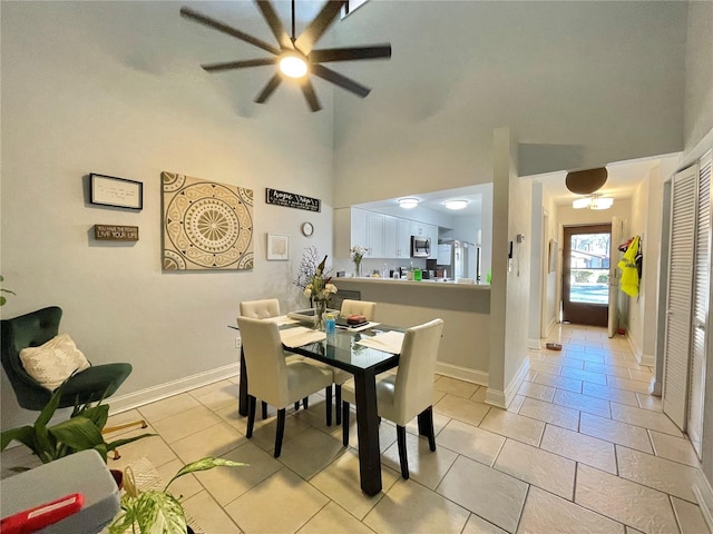 dining space featuring a high ceiling