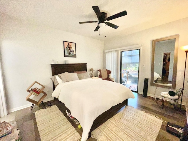 bedroom featuring ceiling fan, dark hardwood / wood-style floors, and access to outside