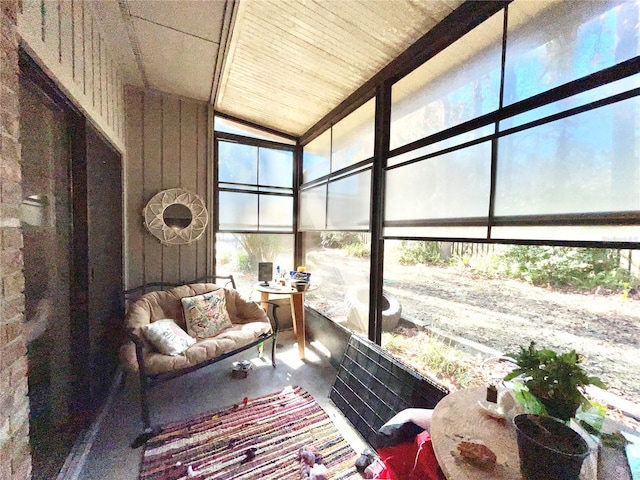 sunroom featuring lofted ceiling and wood ceiling