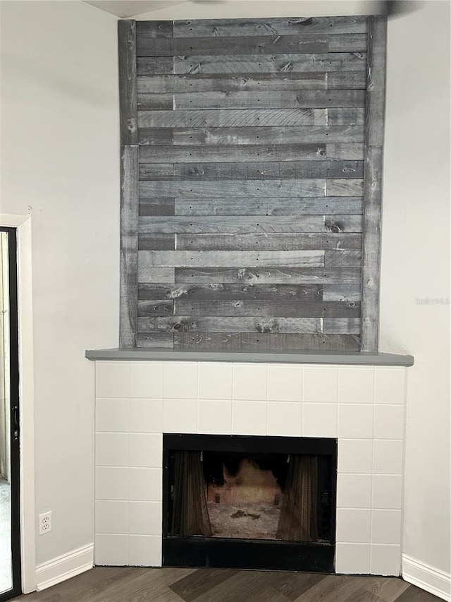 details featuring hardwood / wood-style flooring and a fireplace