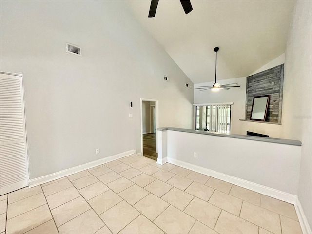 2820 NW 39th Ter, Gainesville, FL 32606 - unfurnished living room with a ceiling fan, high vaulted ceiling, light tile patterned floors, and baseboards