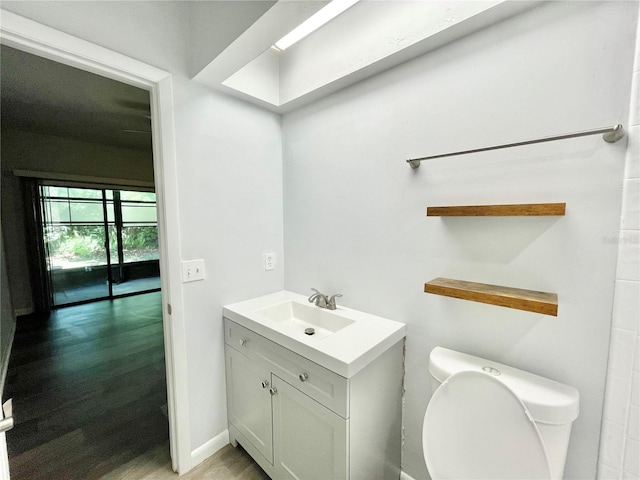 2820 NW 39th Ter, Gainesville, FL 32606 - bathroom with toilet, vanity, and wood finished floors