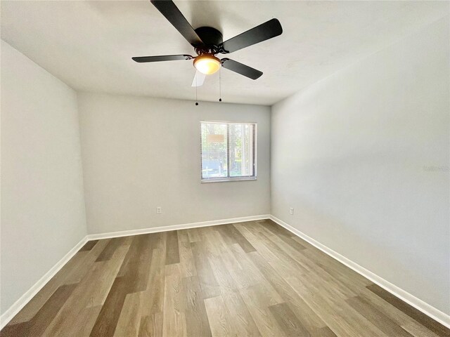 2820 NW 39th Ter, Gainesville, FL 32606 - spare room featuring wood finished floors, baseboards, and ceiling fan