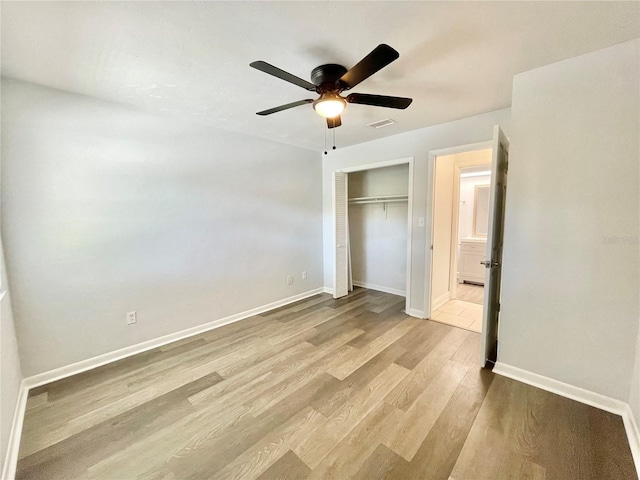 2820 NW 39th Ter, Gainesville, FL 32606 - unfurnished bedroom with wood finished floors, a closet, baseboards, and ceiling fan