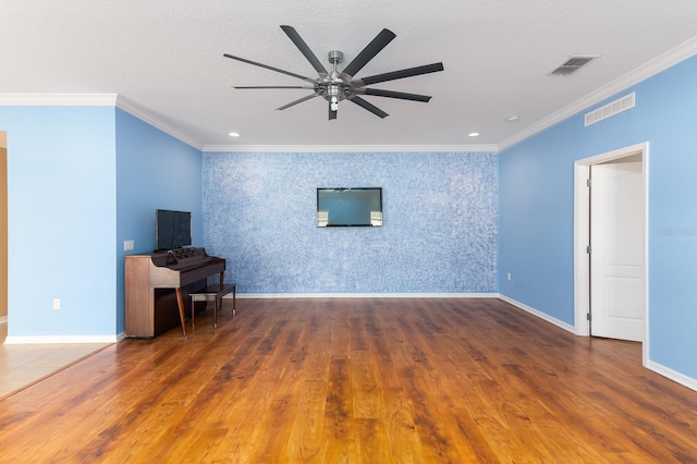 unfurnished living room with dark hardwood / wood-style flooring, ornamental molding, and ceiling fan