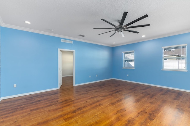 unfurnished room featuring ornamental molding, dark wood-type flooring, and a textured ceiling