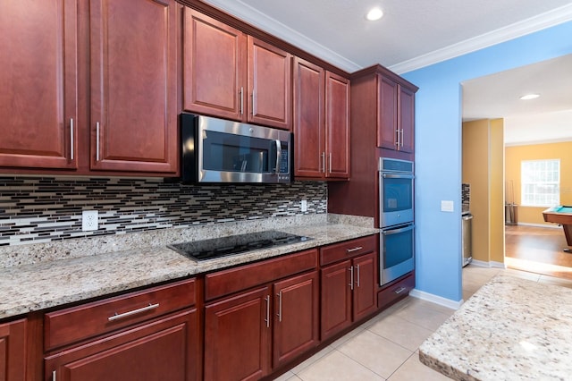 kitchen featuring light tile patterned floors, crown molding, backsplash, stainless steel appliances, and light stone countertops