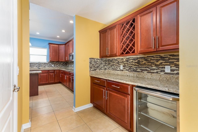 kitchen with light tile patterned floors, sink, wine cooler, tasteful backsplash, and light stone countertops