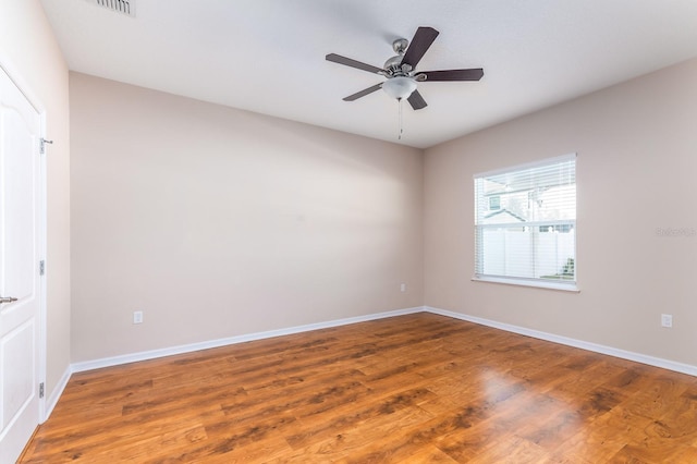 spare room with hardwood / wood-style flooring and ceiling fan