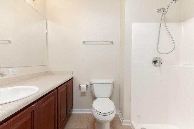 bathroom featuring walk in shower, vanity, toilet, and tile patterned flooring