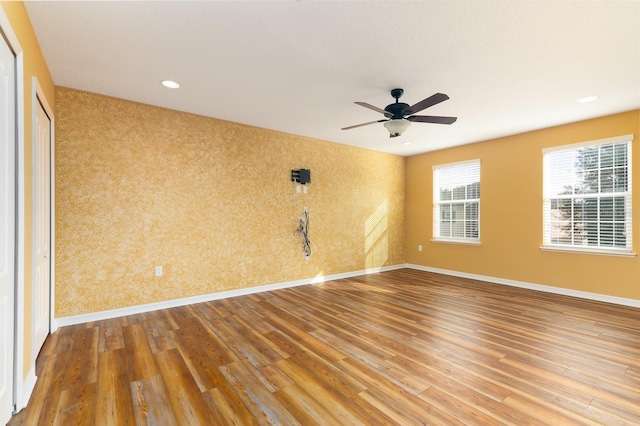 unfurnished room featuring hardwood / wood-style floors and ceiling fan