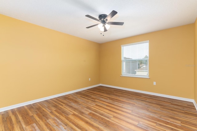 empty room with hardwood / wood-style flooring and ceiling fan