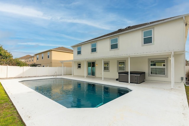 view of swimming pool with a hot tub and a patio area