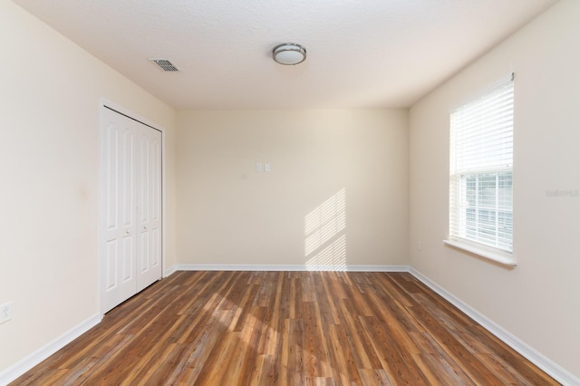 24448 SW 8th Pl, Newberry, FL 32669 - unfurnished bedroom featuring wood finished floors, a closet, and baseboards