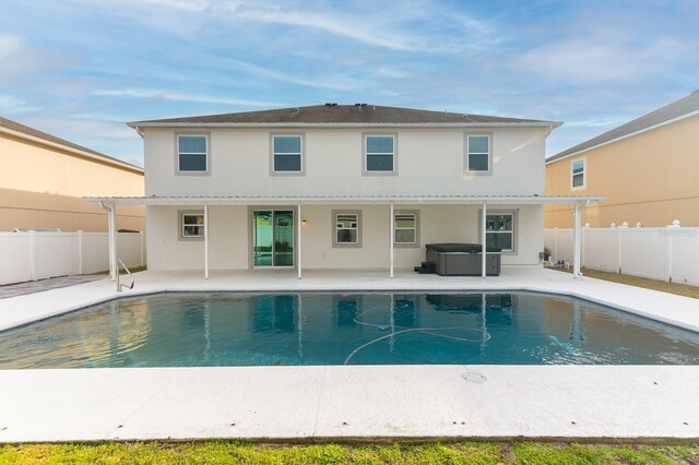 24448 SW 8th Pl, Newberry, FL 32669 - back of property featuring a covered hot tub, a patio, and stucco siding
