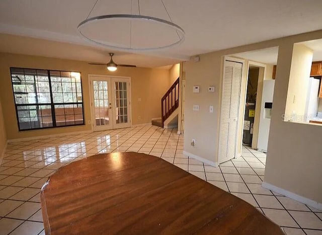 spare room featuring light tile patterned floors and french doors