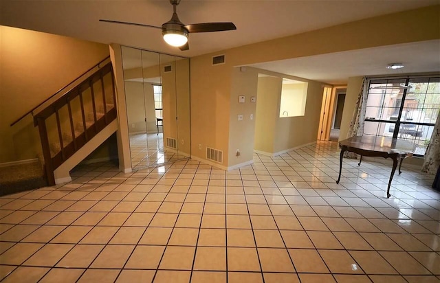 spare room featuring light tile patterned floors and ceiling fan