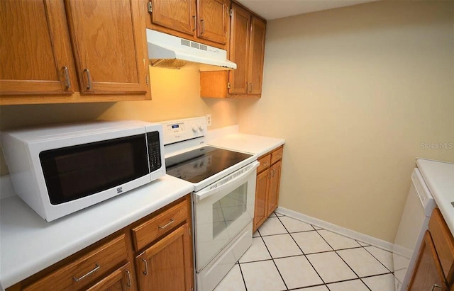 kitchen featuring light tile patterned floors and white appliances