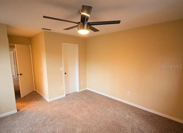 unfurnished bedroom with ceiling fan and carpet