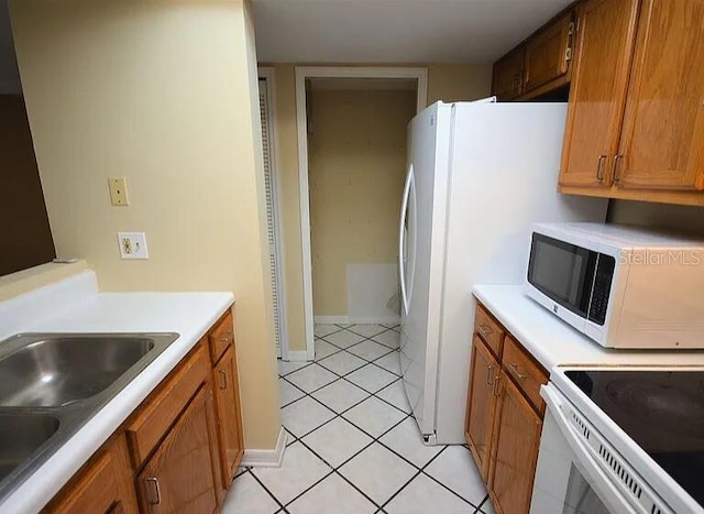 kitchen featuring sink and light tile patterned flooring