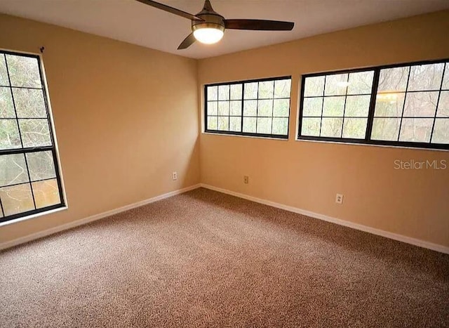 carpeted spare room with ceiling fan