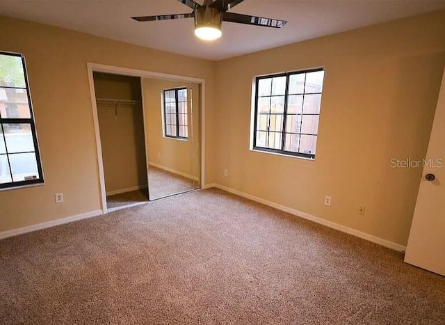 unfurnished bedroom featuring ceiling fan, a closet, and carpet