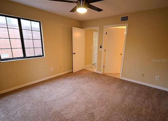 unfurnished bedroom with ceiling fan and light carpet