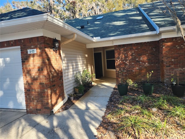 doorway to property with a garage