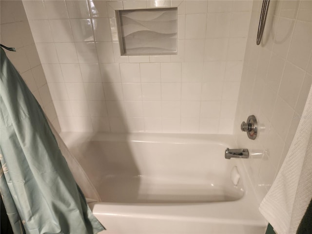 bathroom with shower / bath combo with shower curtain