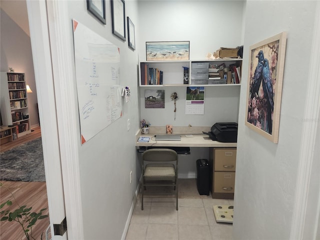 office featuring light tile patterned floors and built in desk