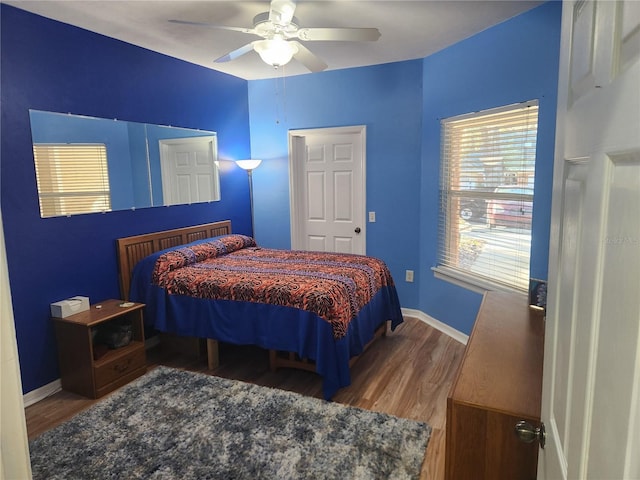 bedroom with hardwood / wood-style floors and ceiling fan