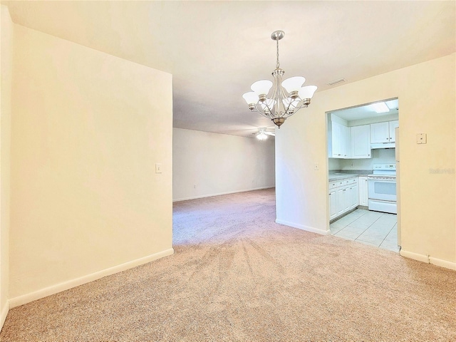 unfurnished room featuring light carpet and a notable chandelier