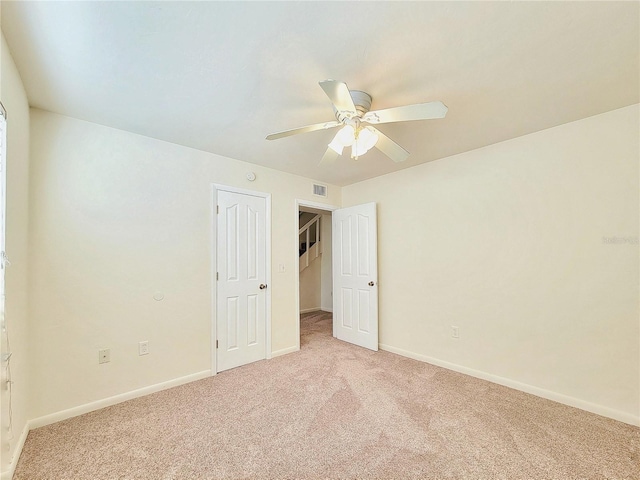 spare room with light carpet and ceiling fan