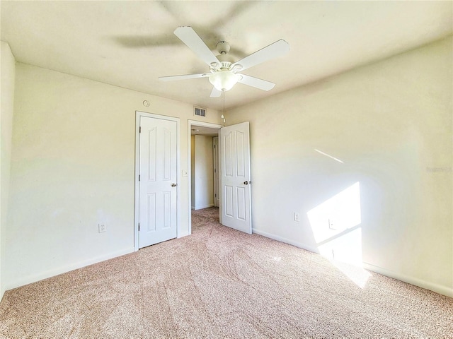 unfurnished bedroom with ceiling fan and carpet