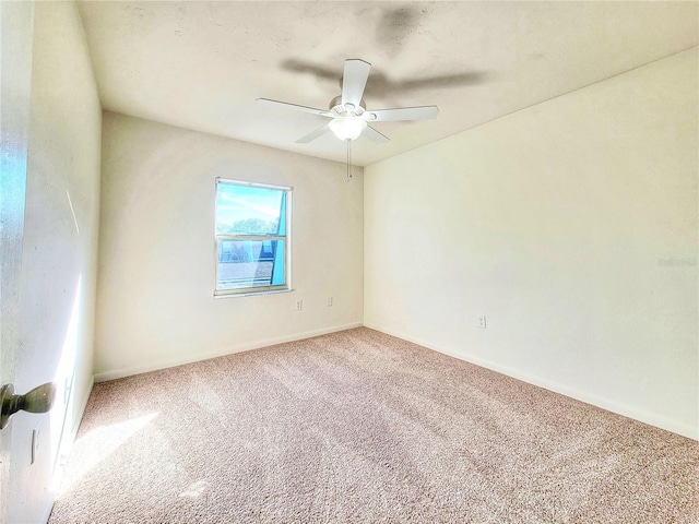 spare room with ceiling fan and carpet