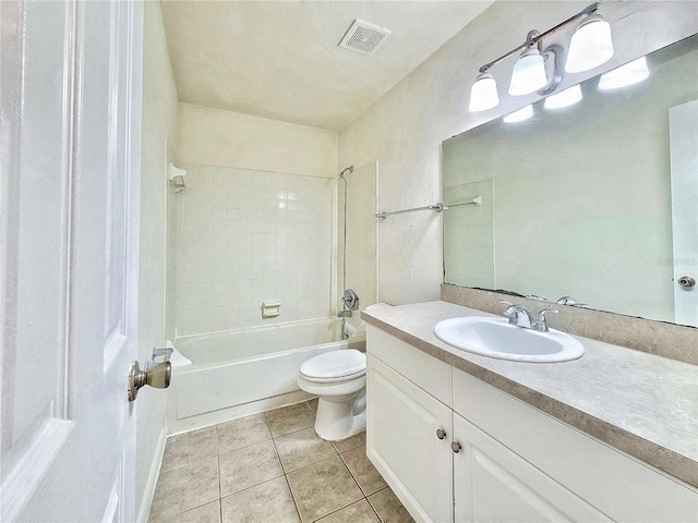 full bathroom with tiled shower / bath, vanity, tile patterned floors, and toilet