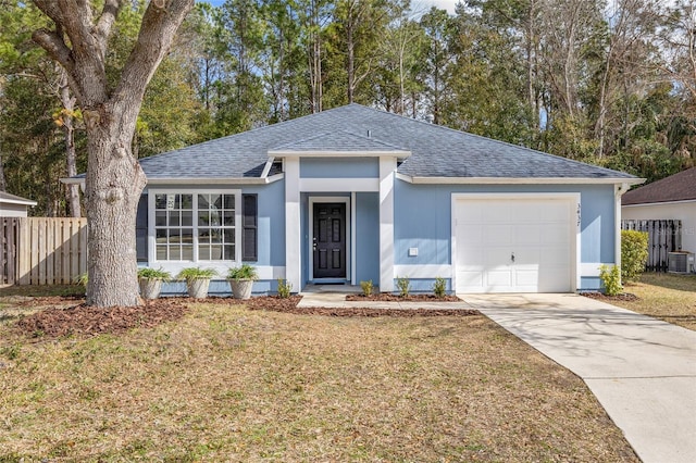 ranch-style house with central AC unit, a garage, and a front yard