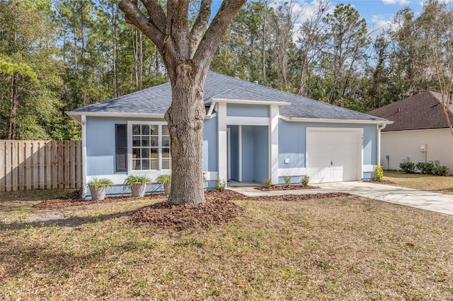 ranch-style house featuring a garage and a front lawn