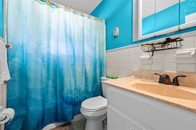 bathroom featuring walk in shower, vanity, toilet, and tile walls